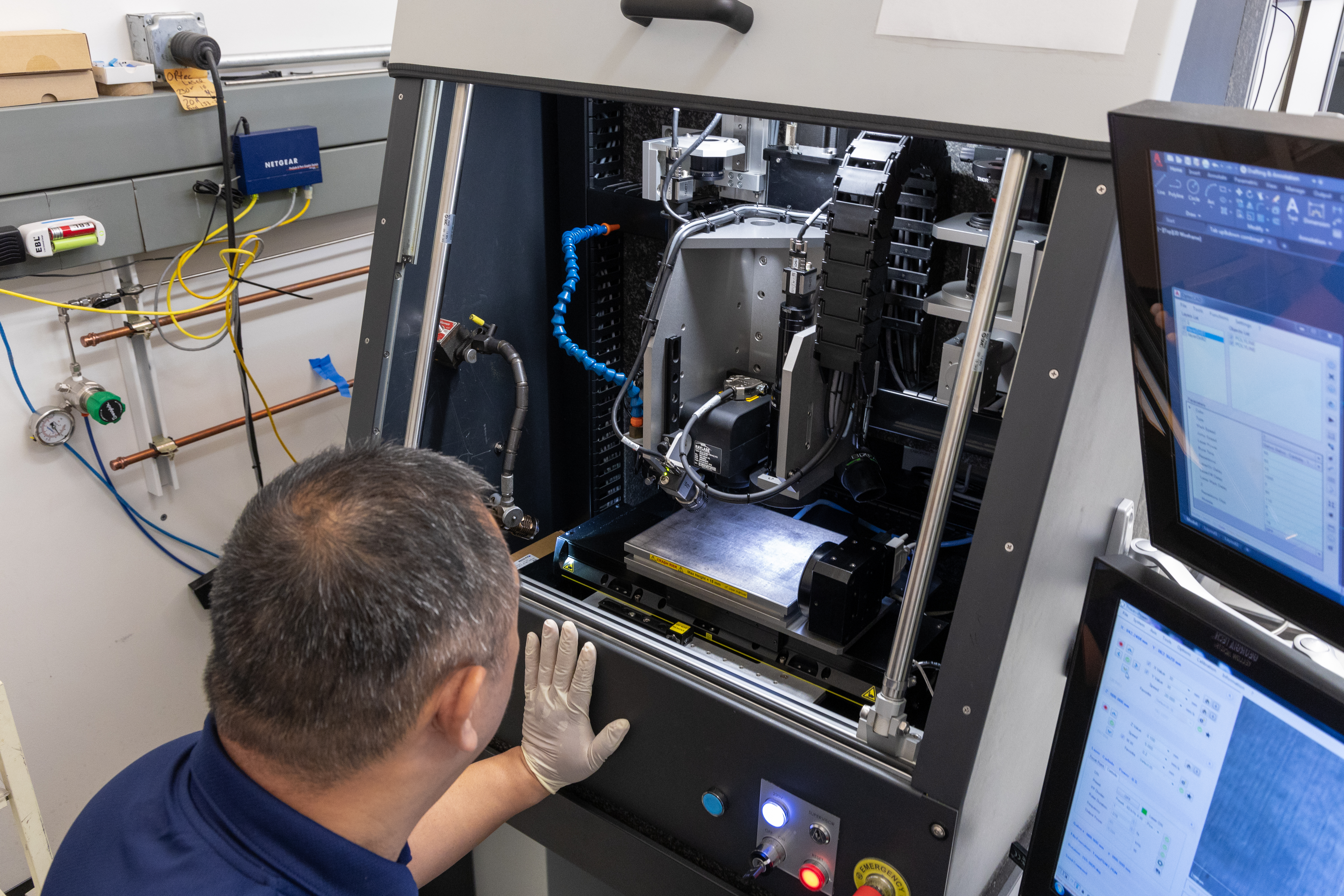 Senior Research Engineer Henry Su looks into the Optec WS Flex Femtosecond Laser​