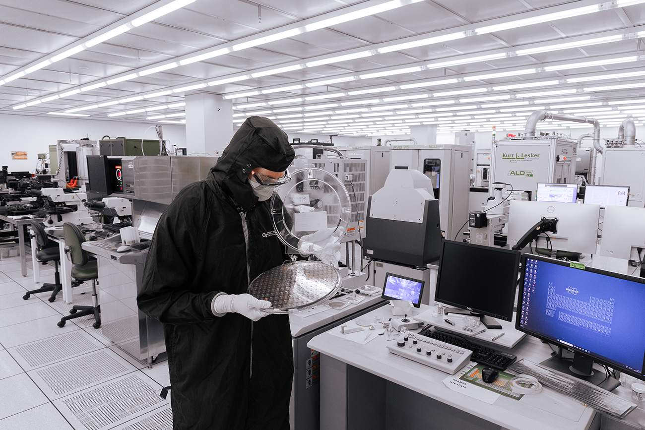 scientists in cleanroom working