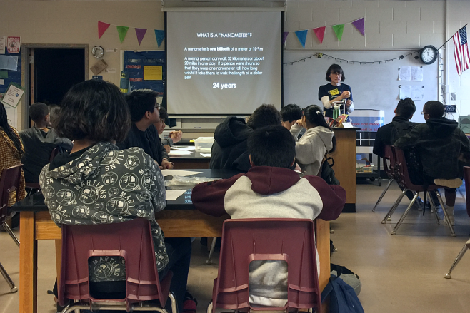 The Institute for Matter and Systems education and outreach office go in a classroom teaching.