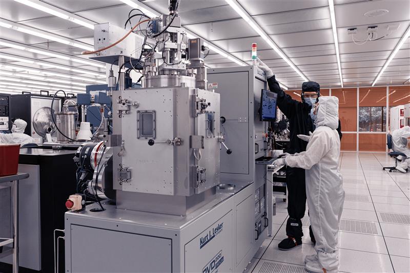 Student working with IMS staff member in the cleanroom