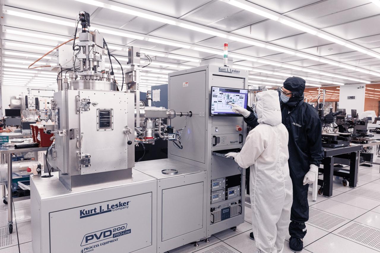 Student working with IMS staff member in the cleanroom