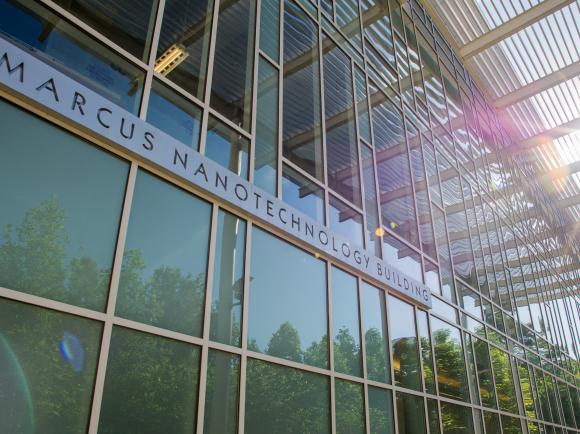 Photo of the Marcus Nanotechnology Building. A glass building with sunshine shining through in the top right corner. 