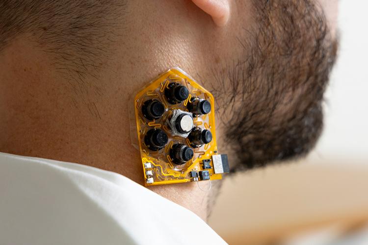 a patch of haptic actuators shown on a user's neck