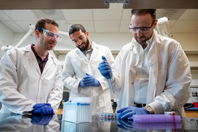 Alex Abramson, Ramy Ghanim, and Abdulraouf Abbas working in the lab.