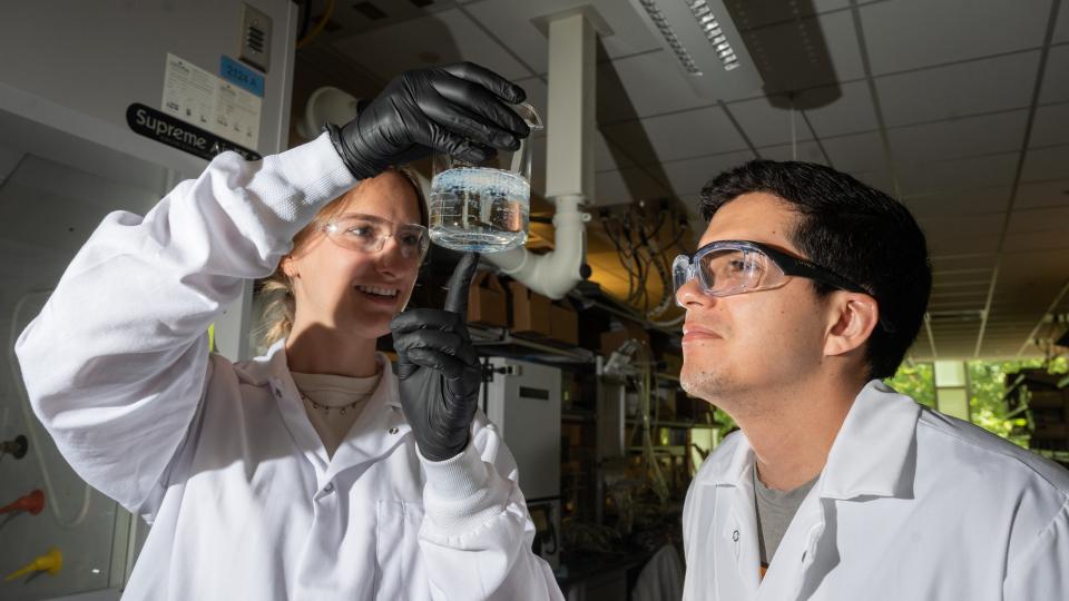 Erik Barbosa and Madeline Morrell examine salt beads.JPG