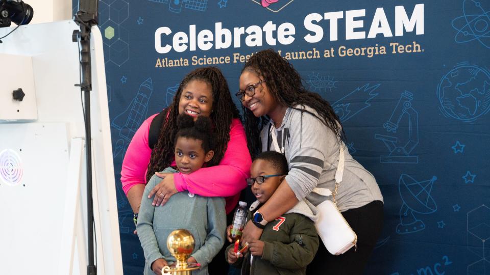A family poses for a special moment in the Celebrate STEAM photo booth during Georgia Tech&#039;s Celebrate STEAM event on March 8.