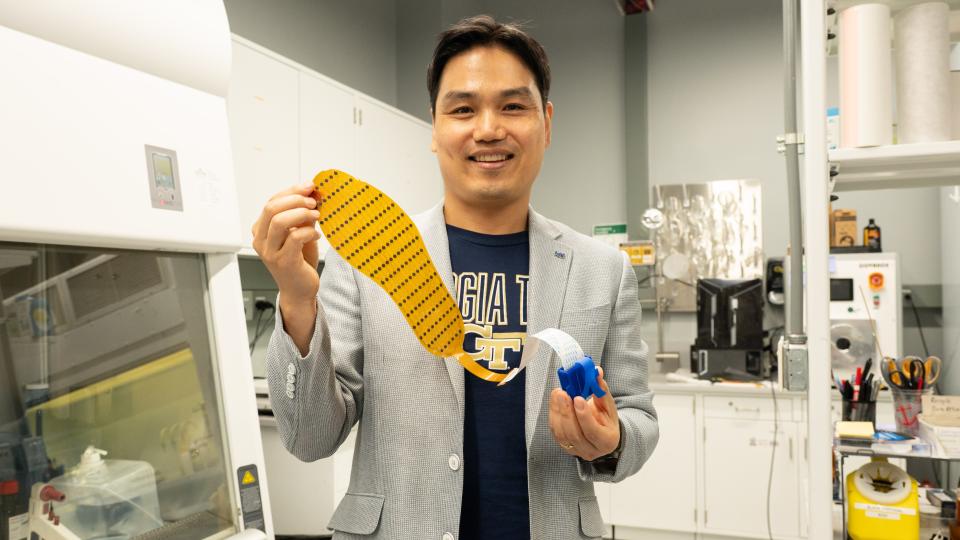 Hong Yeo holds shoe insert.